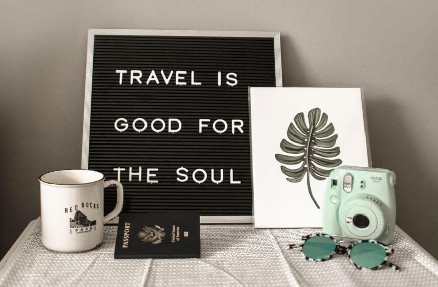 a table setting that says "travel is good for the soul"