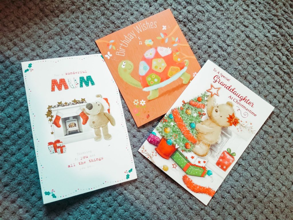 3 greetings cards laying on the floor
