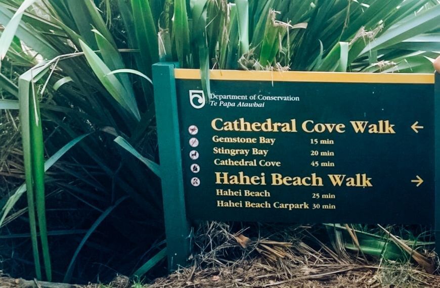 cathedral cove sign with time distances to each cove on the walkway