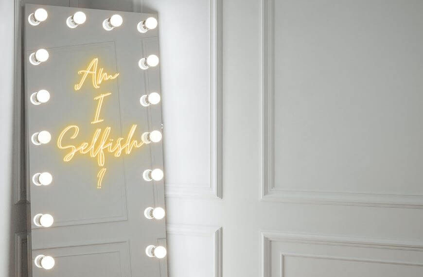 a mirror with writing on that reads "am i selfish?"