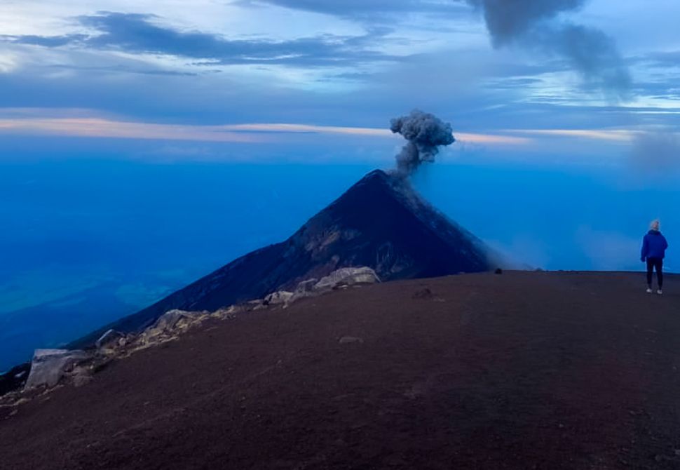 A slightly cloudy view of Fuego erupting from the summit of Acatenango