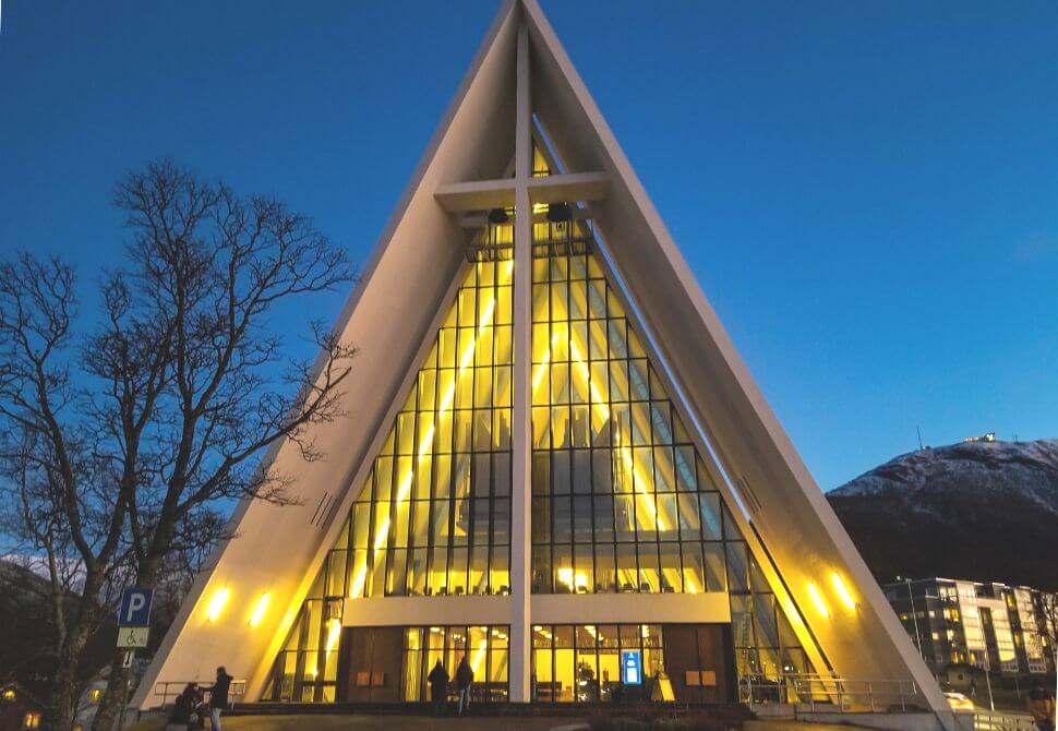 Arctic cathedral lit up at night - visiting this building is one of the best things to do in Tromso