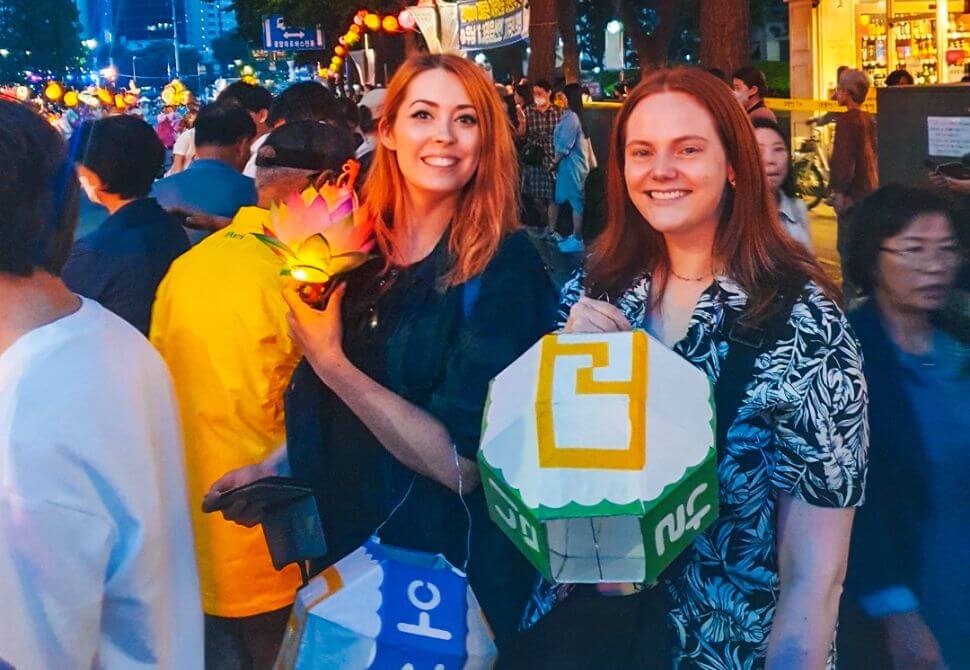my friend and i holding lanterns at the parade