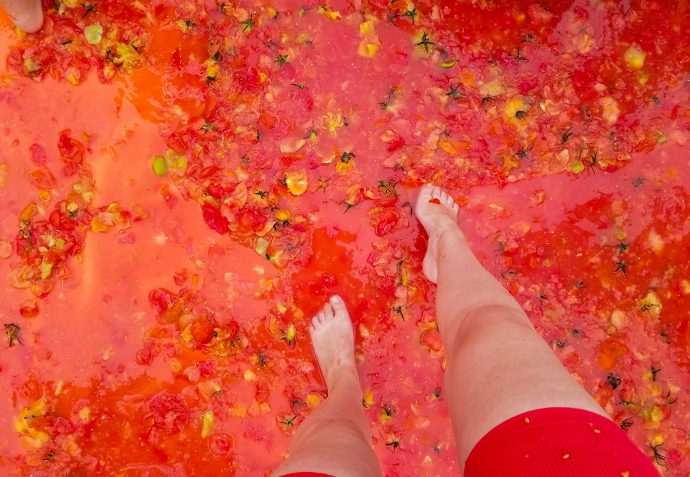 Feet standing in a pool of tomato sauce at the Hwacheon Tomato Festival in Korea