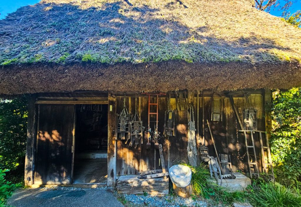 Gassho house with traditional tools lined up outside. Gero gassho onsen village